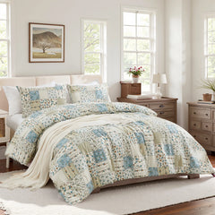 Full view of the green patchwork duvet cover set on a bed in a light-filled bedroom