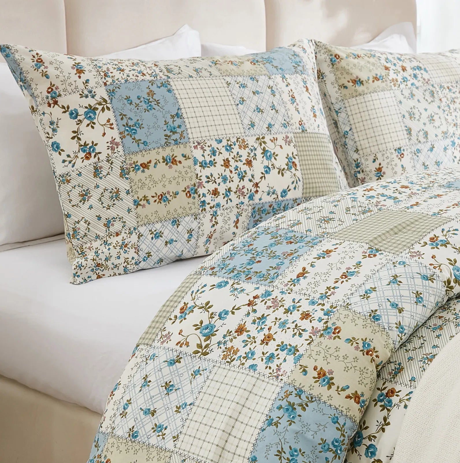 A close-up of the textured green patchwork pattern on the duvet cover