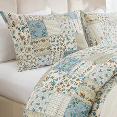 A close-up of the textured green patchwork pattern on the duvet cover