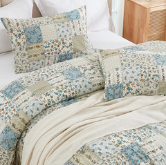 Close-up of the stitching and varied patchwork fabrics on the duvet cover