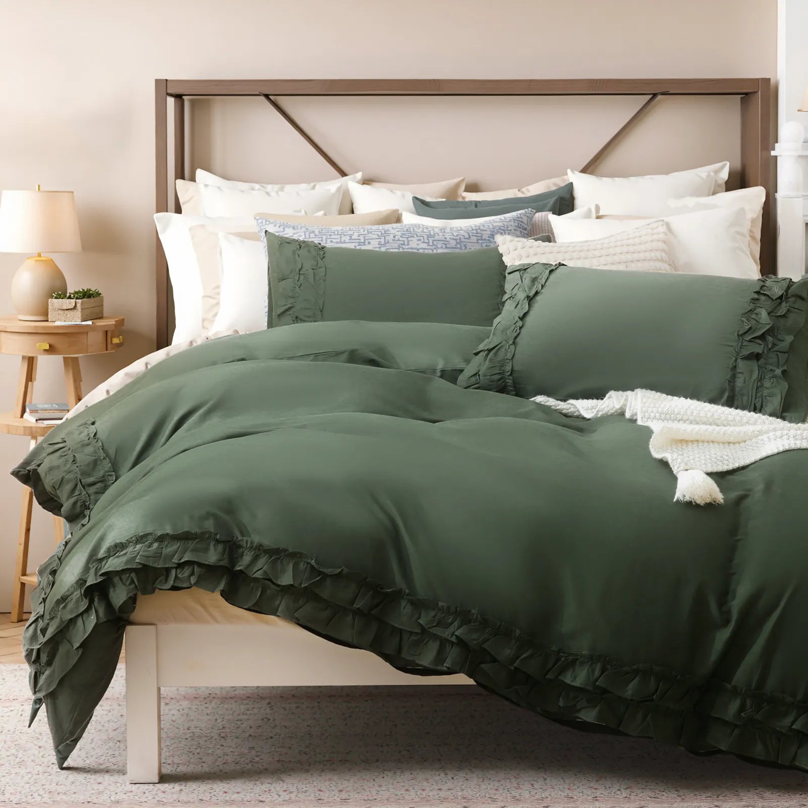 Angled view of the green ruffled comforter set showing the full bed and pillows