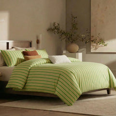 Angled shot of green striped duvet cover on bed