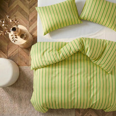 Overhead flat lay of green striped duvet and cases