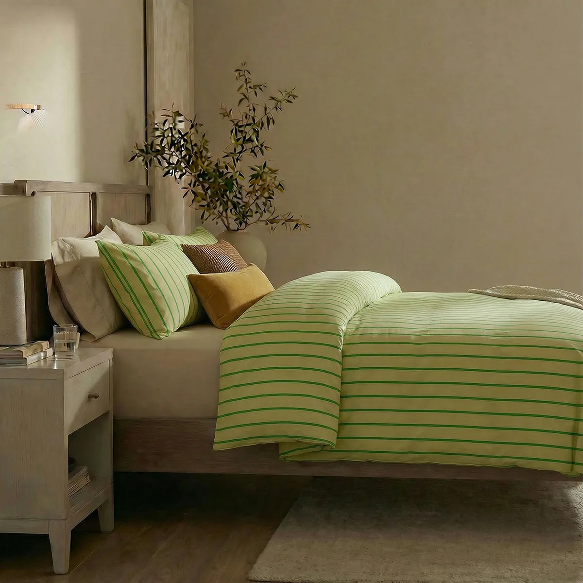 Side view of green striped duvet and pillows
