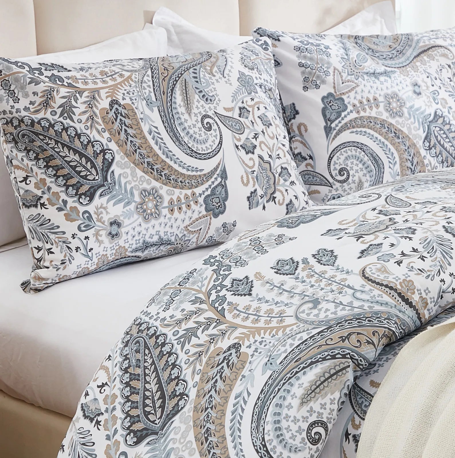 Close-up shot of the grey paisley duvet cover from a bed corner angle.