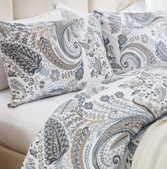 Close-up shot of the grey paisley duvet cover from a bed corner angle.