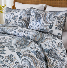 Close-up shot of the intricate grey paisley pattern and stitching on the quilt.