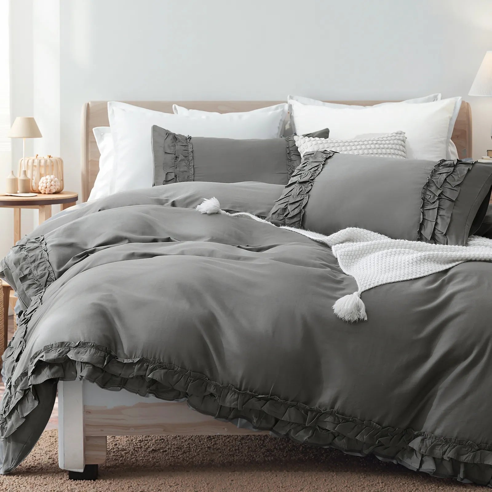 Angled view of the grey comforter set showing the full bed and pillows