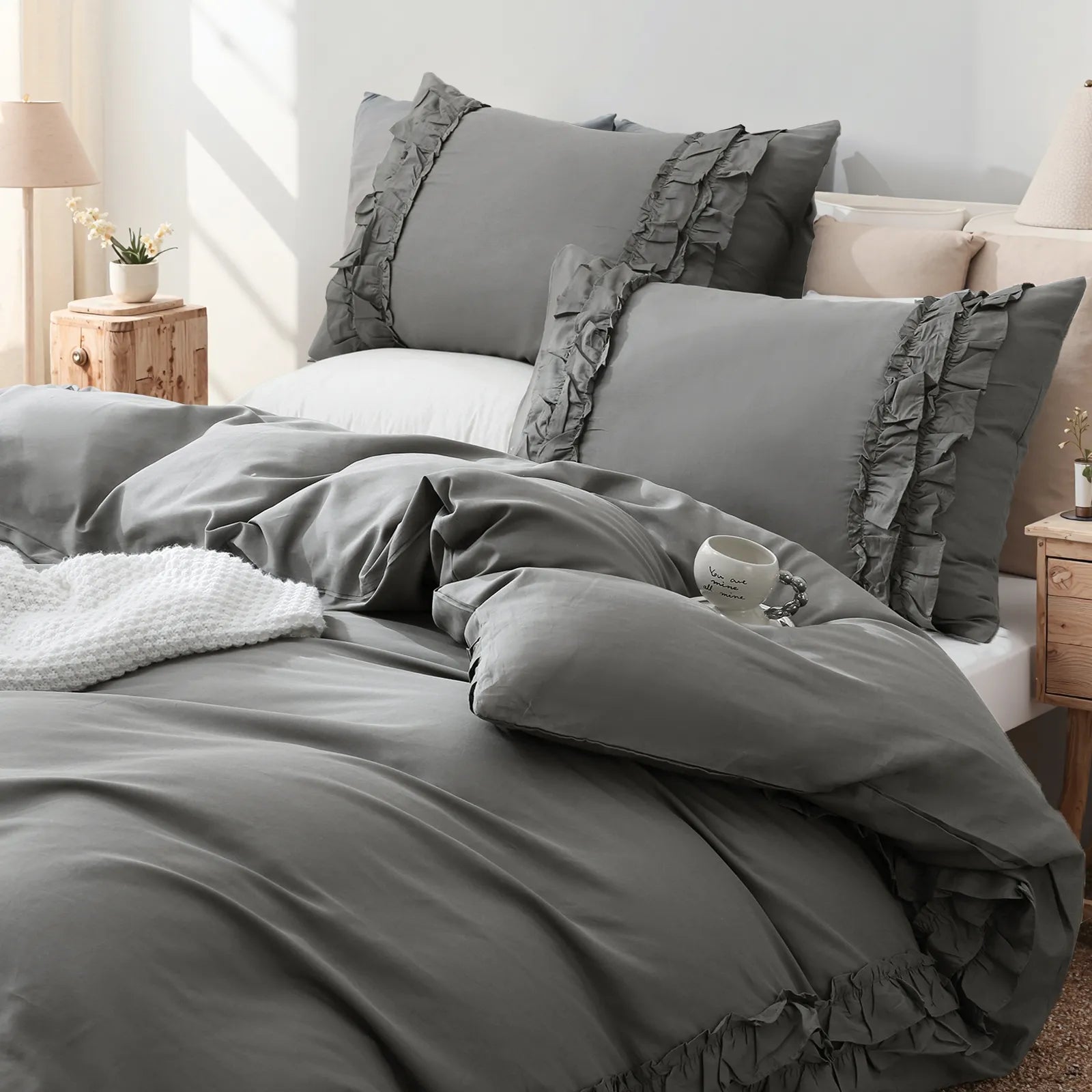 Close-up shot of the grey ruffled edge on the corner of the white comforter