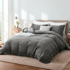 Side view of the grey ruffled comforter set, highlighting the texture and drape