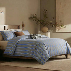 Angled shot of grey blue striped duvet cover on bed