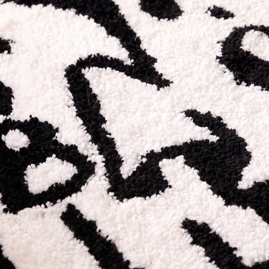 happy haunting rug boo crew black white plush texture close up