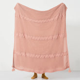 Person Holding Up Rose Pink Throw Blanket with Cable Knit Texture