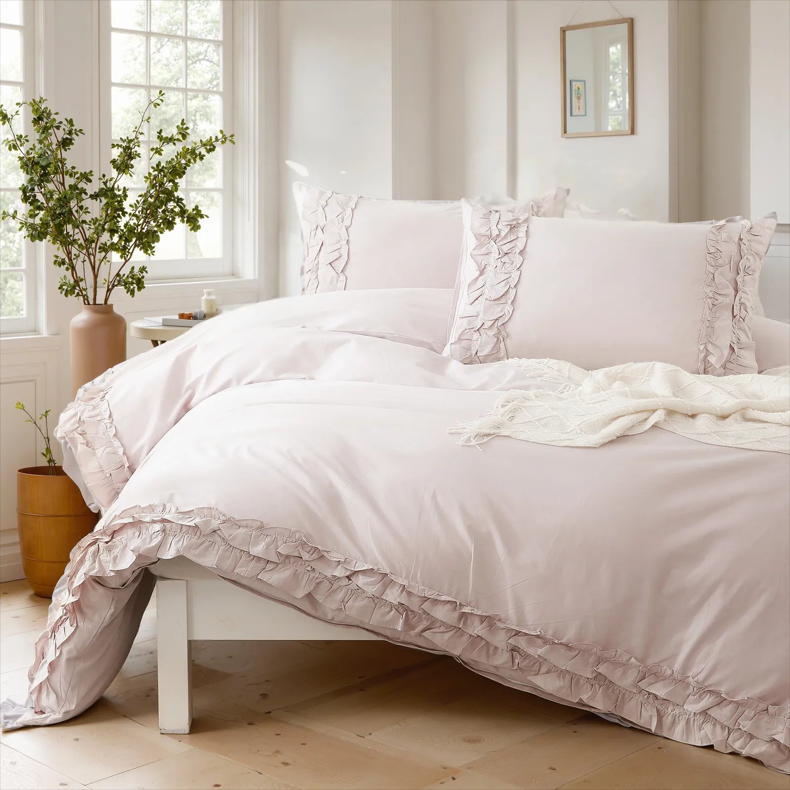 Lavender cotton double ruffle duvet cover on a white bed frame, with a mirror on the wall and soft lighting.