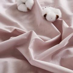 Close-up of lavender duvet fabric showing cotton bolls with brown seeds