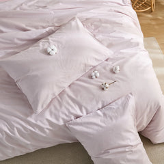 Top view of lavender solid duvet with scattered cotton blooms on surface