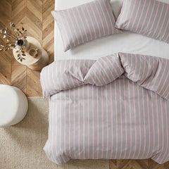 Overhead flat lay of light grey and pink striped duvet and cases
