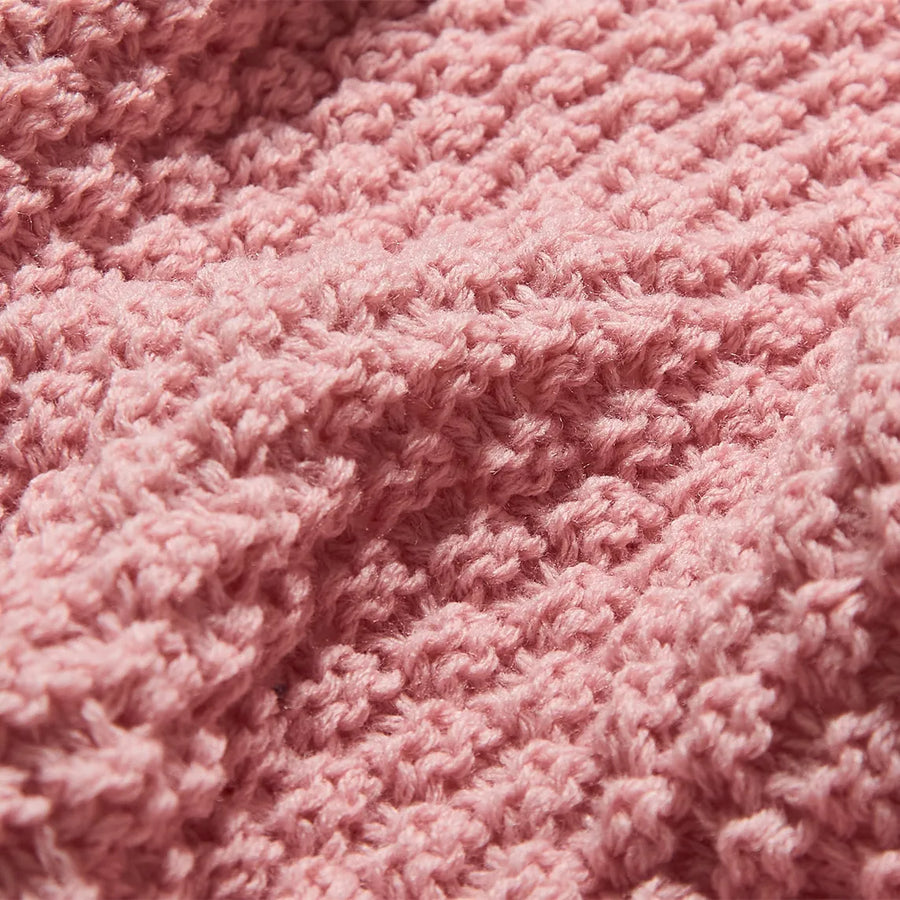 Macro Close-up of Pink Knitted Fabric Texture and Weave