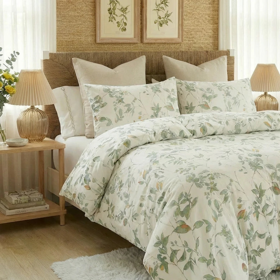 sage green botanical duvet cover styled with warm lighting and rustic bedroom decor