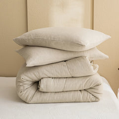 The folded natural linen comforter and matching pillowcases for display
