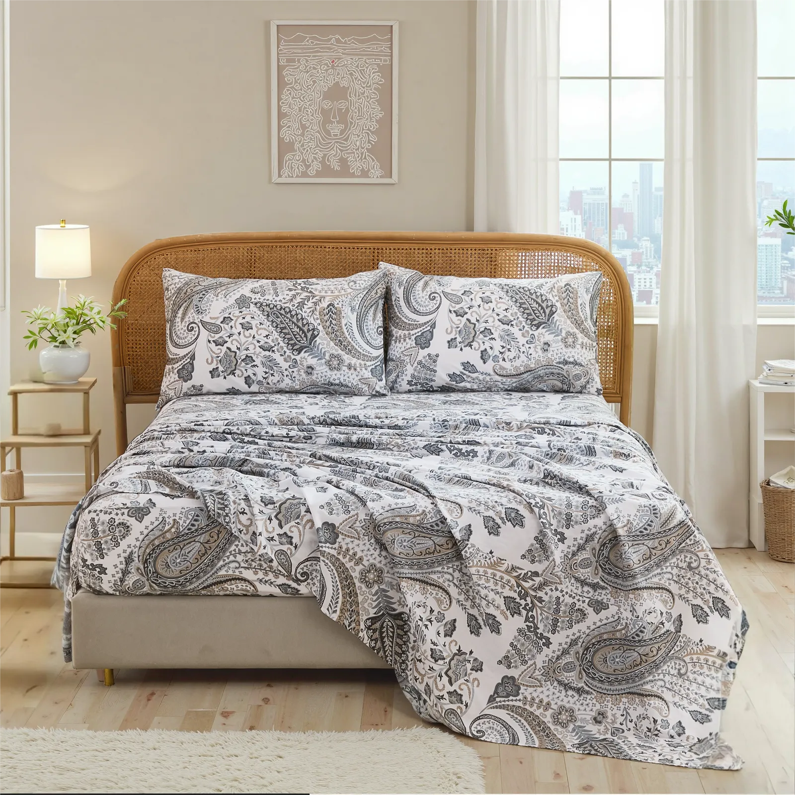 Close up view of cotton neutral paisley sheet set on bed with rustic rattan headboard