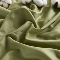 Olive green duvet cover with two cotton buds on wrinkled fabric, front view