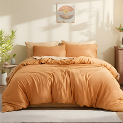 Front view of orange duvet showing texture and folds on sheets.