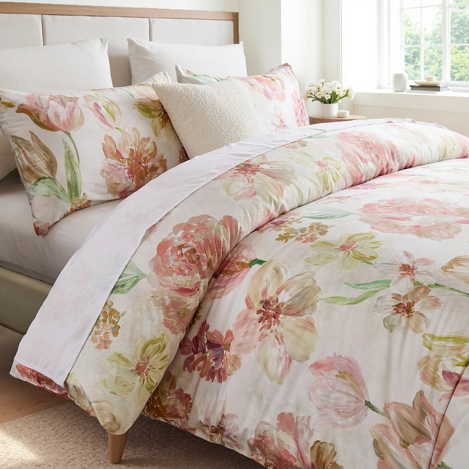 Angled view of the floral comforter and pillows on the bed