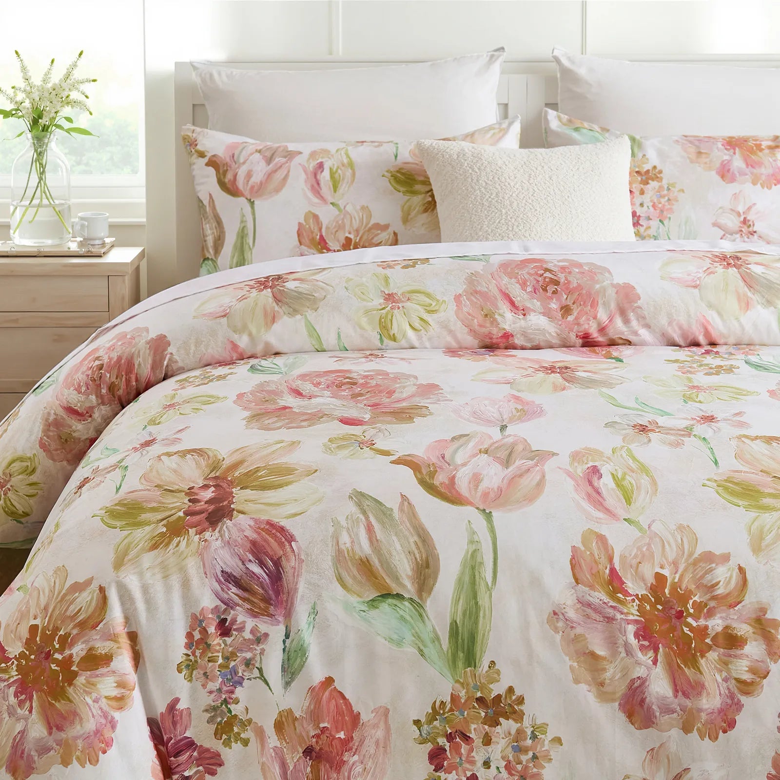 Close-up of the pink floral comforter and pillows on the bed
