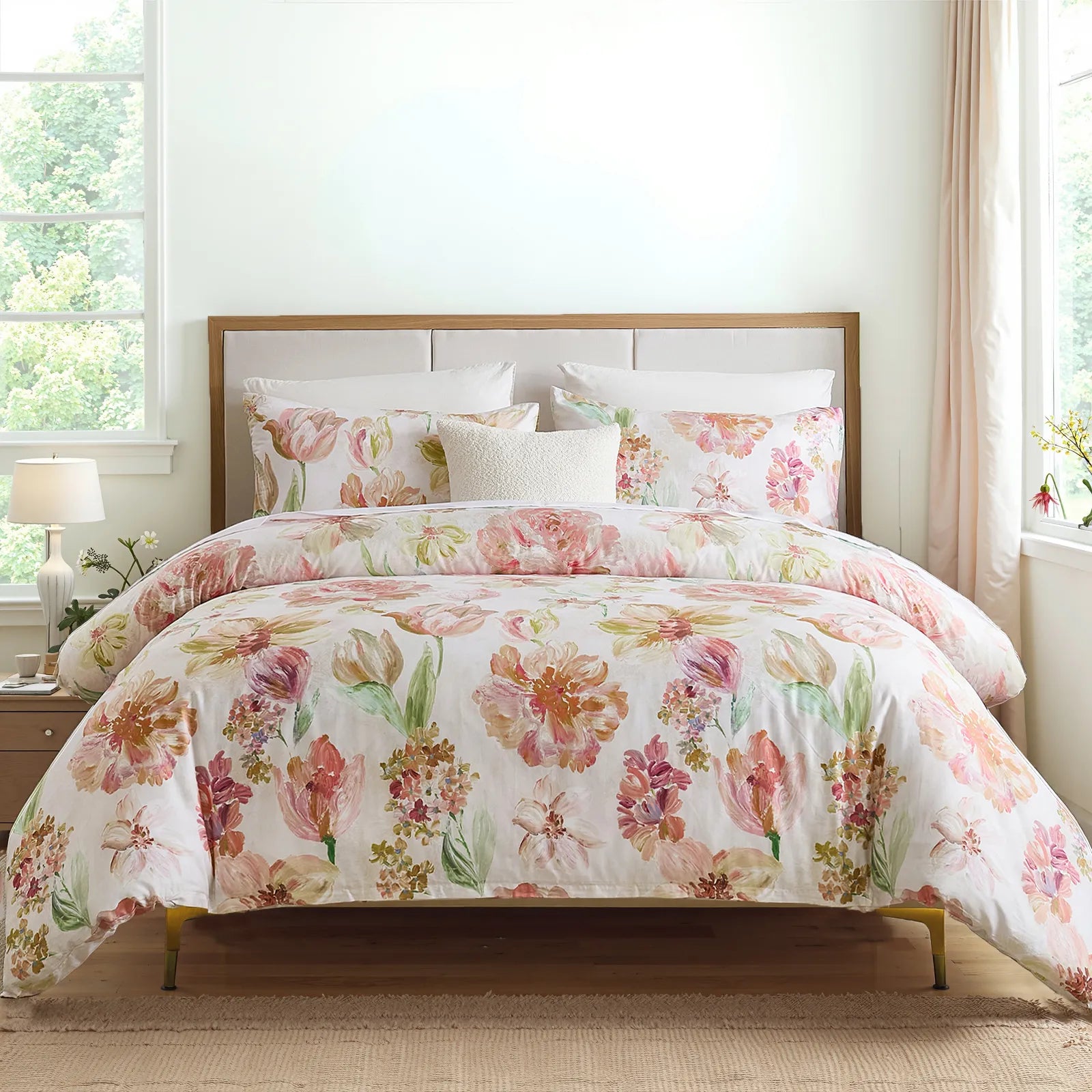 Pink floral cotton comforter set on a bed with a wooden headboard