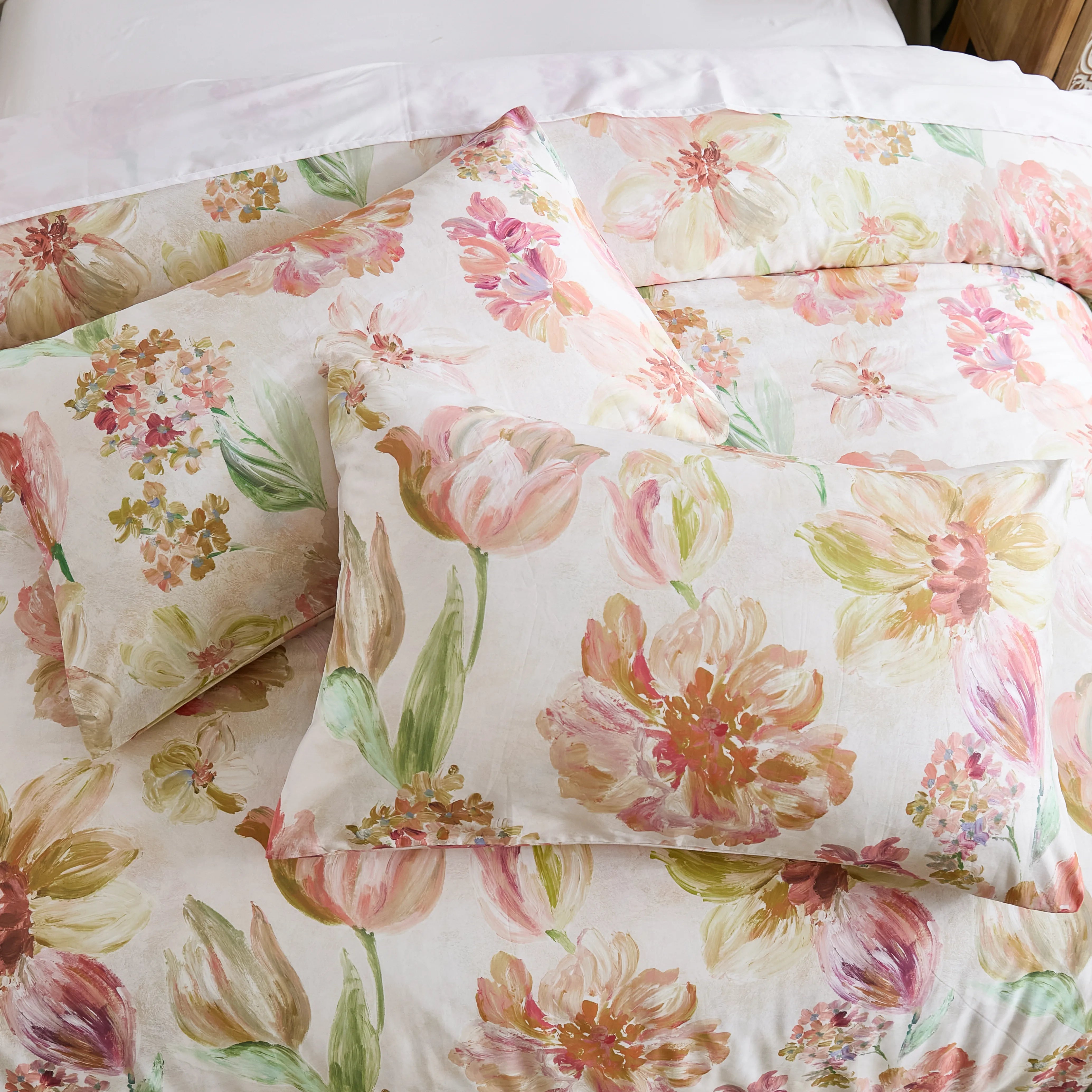 Top-down view of the pink floral comforter and pillow set