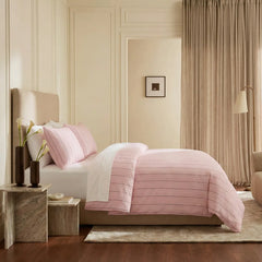 Side view of pink striped duvet and pillows
