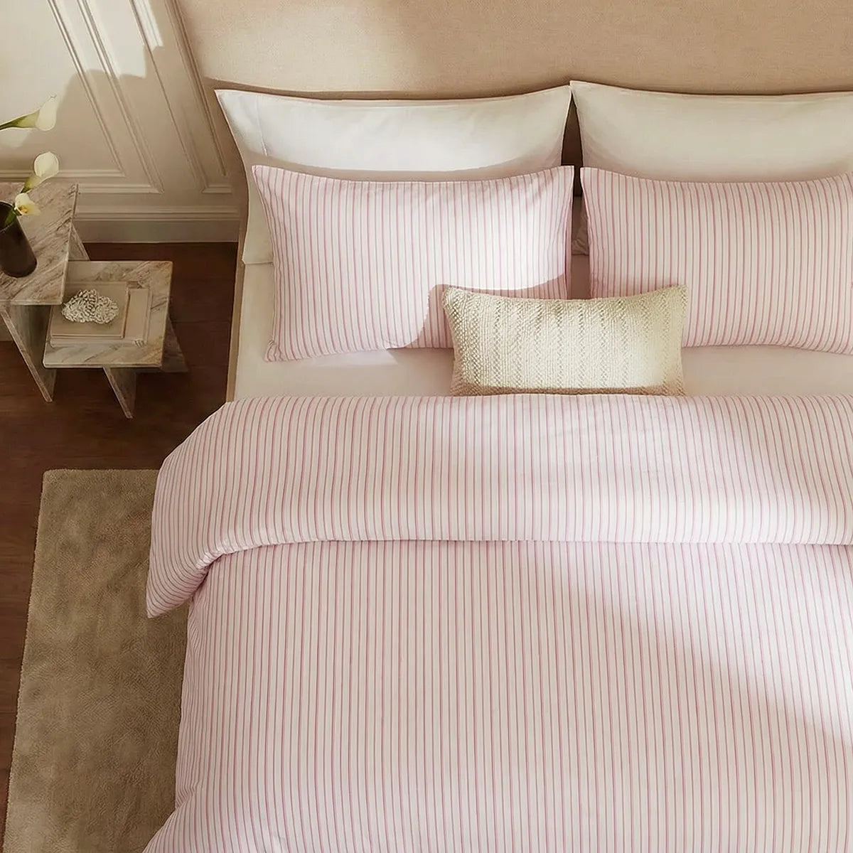 Overhead flat lay of pink and white striped duvet and cases