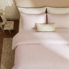 Overhead flat lay of pink and white striped duvet and cases