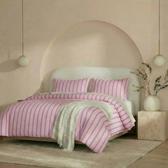 Angled shot of pink purple striped duvet cover on bed