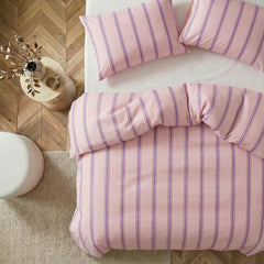 Overhead flat lay of pink purple striped duvet and cases