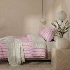 Side view of pink purple striped duvet and pillows