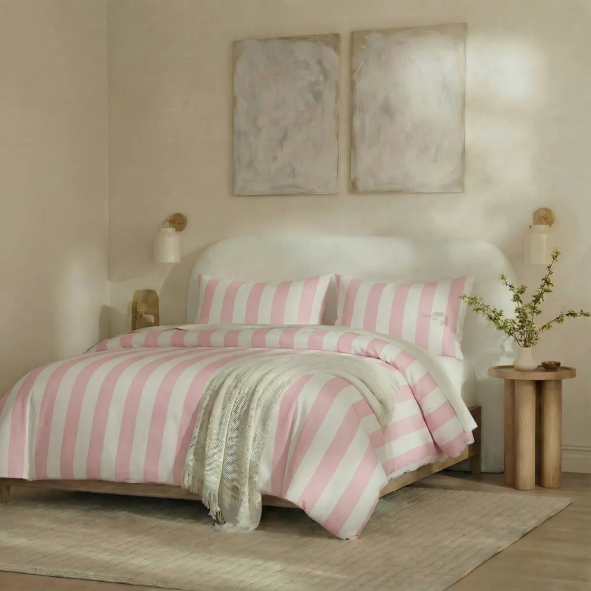 Angled shot of pink and white striped duvet cover on bed