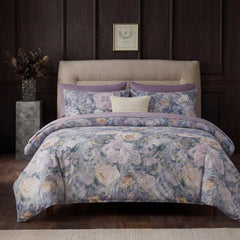 Full front view of the purple floral lace bedding set in a room