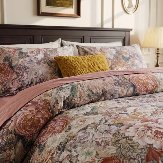 close-up of rich rose and amber oil-paint style floral pattern on 100 percent natural cotton bedding