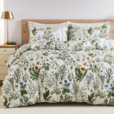 A full view of the sage green floral duvet cover set styled on a bed.