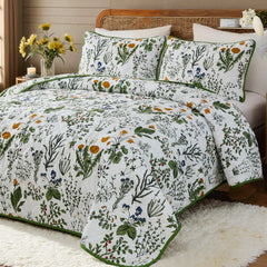 An inviting angled view of the sage green floral quilt set with pillows.