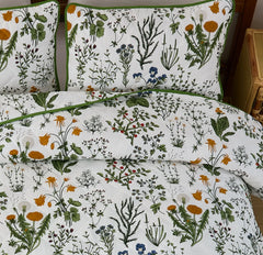 Close-up shot of the elegant sage green floral pattern on the quilt