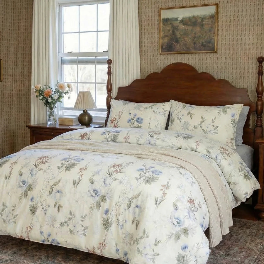 profile view of the serene garden bloom bedding set styled with a cream throw in a cozy room