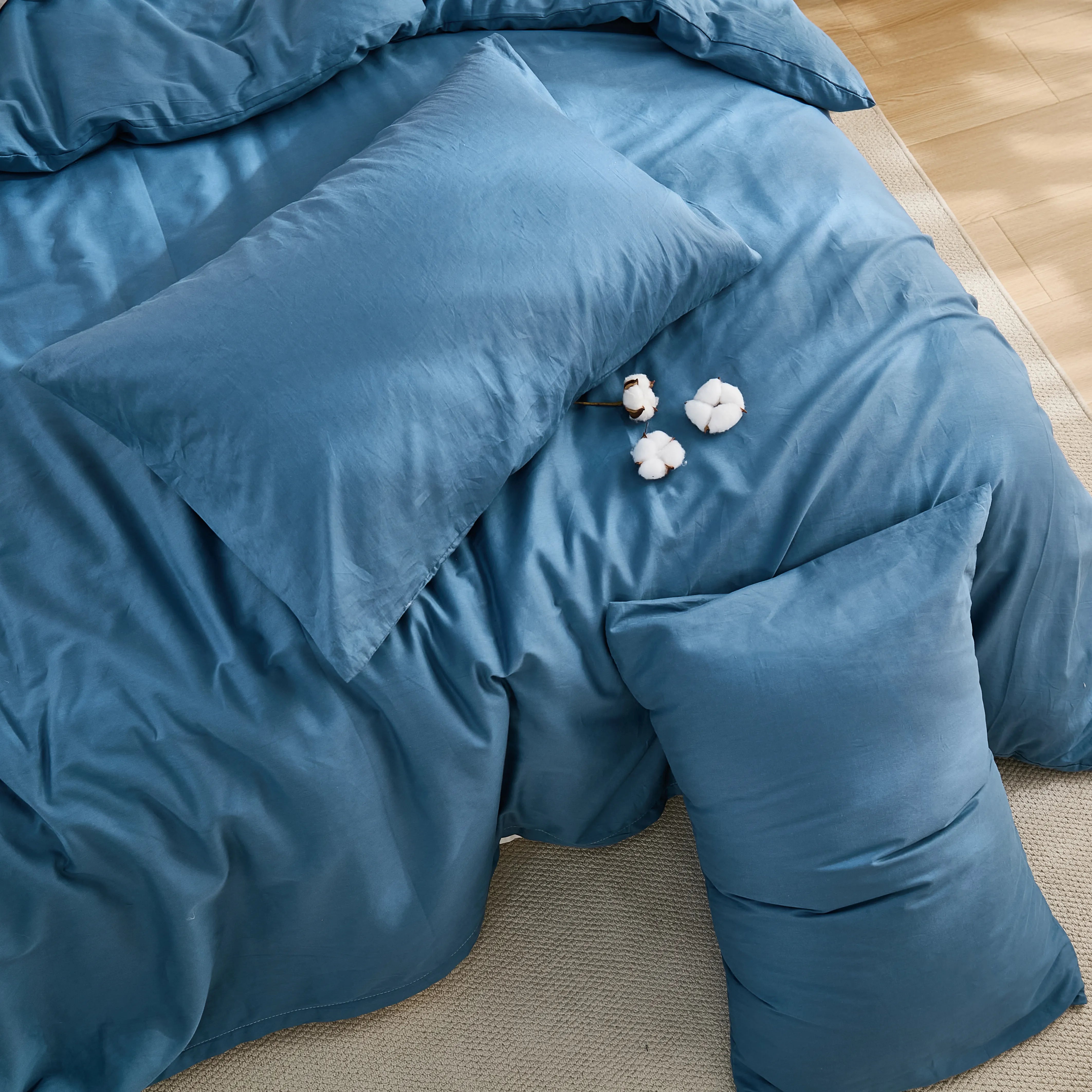 Soft blue fabric with natural folds and three cotton placements