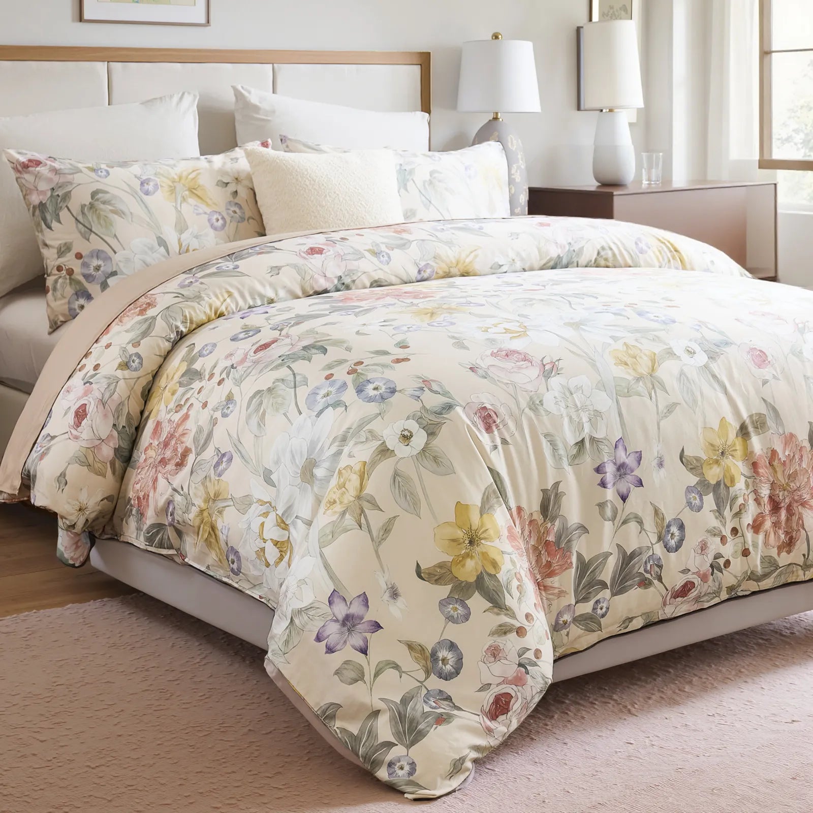 Close-up shot of the floral comforter on a bed with pillows