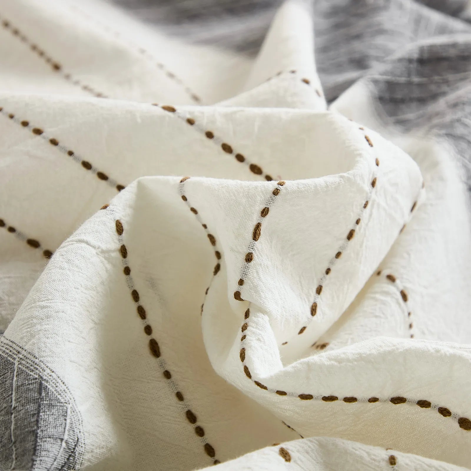 close up of brown dashed embroidery