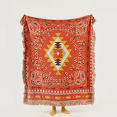 Full view of terracotta boho cotton throw displaying central diamond and arrows motif