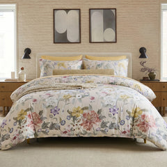 Front view of vintage floral duvet cover set with yellow accent pillows on a platform bed