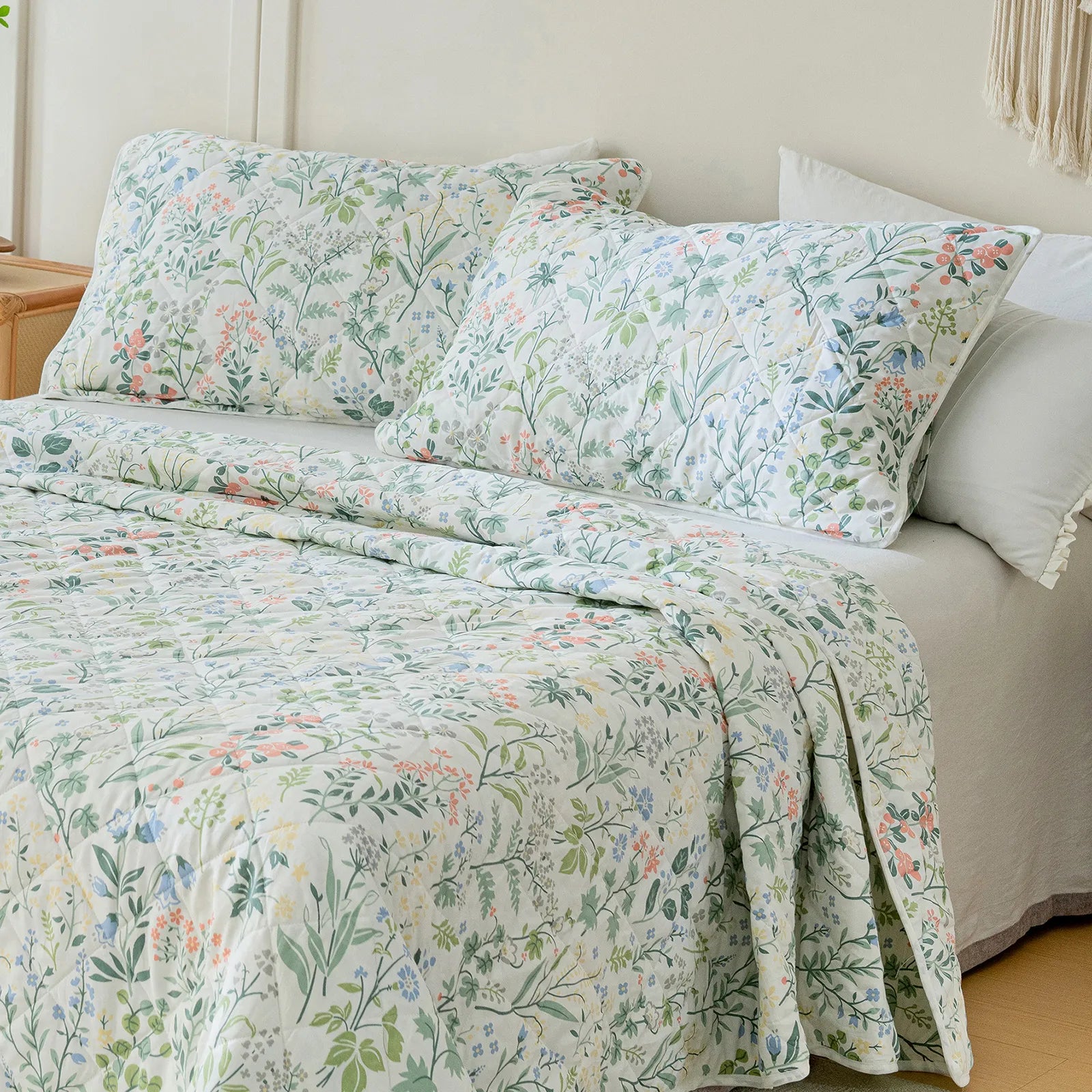 A detailed shot of the quilt from a bed corner angle, showing the design.